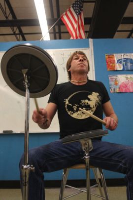 Ithaca College facilities attendant Terrence Flanigan rocks out Nov. 18 at DeWitt Middle School during the after-school drum lesson he teaches.  Elizabeth Sile/The Ithacan