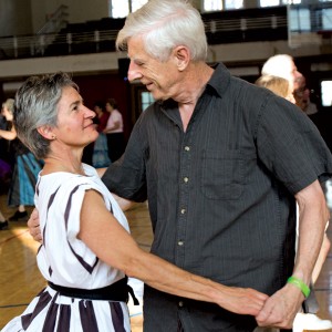 Community members come together to contra dance Friday in the Bethel Grove Community Center. 