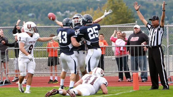 Junior tight end Steve DelMoro, center, celebrates with senior fullback Michael Moon and junior tight end Jared Prugar after catching the game-tying touchdown in the fourth quarter of the Bombers dramatic 27-24 overtime victory against Union College on Saturday.