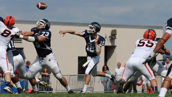 Junior quarterback Phil Neumann delivers a pass during the Bombers 40-22 win against Utica College on Saturday at Butterfield Stadium. 