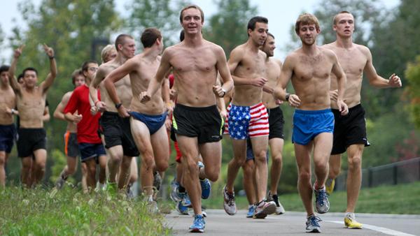 The mens cross country team runs by the Athletics and Events Center during a practice Friday afternoon.