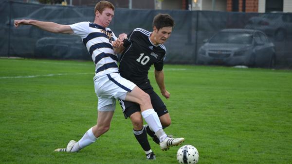 From left, sophomore midfielder Liam Joy extends for the ball while Houghton College junior Paul Seddon tries to keep possession during the Bombers 1-0 overtime win Saturday on Carp Wood Field.