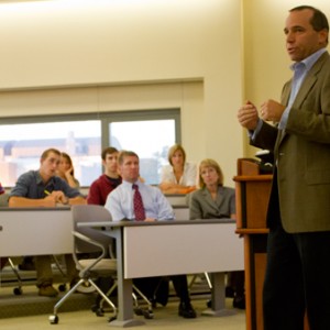 Sam Villanti speaks to a packed room of students.