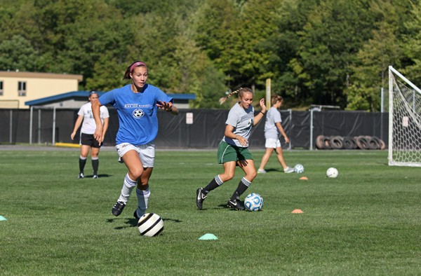 From left, sophomore Kelly Pantason and freshman Kelsey King dribble in womens soccer practice Tuesday afternoon on the Upper Terrace practice fields.