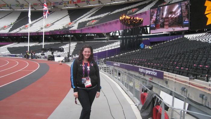 Erin Dunphy stands next to the track at the London Olympics. 