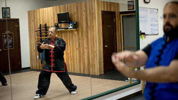 From left, Kevin Hufford, of Trumansburg, leads a Tai Jai Qigong class while Jake Weiskoff follows his movements on Sept. 25 at Dragon Fire Martial Arts Studio.