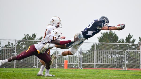 From left, Salisbury junior linebacker James White and junior defensive back Greg Stanton try to bring down Ithaca senior wide receiver Joe Ingrao while he dives for the endzone during the Bombers 21-14 victory on Saturday.