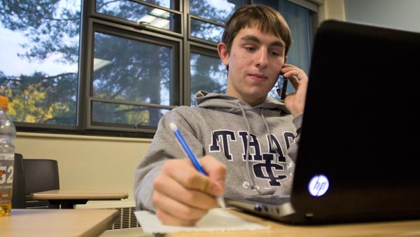 Freshman David Lesnefsky, member of IC Democrats, makes a phone call to a potential voter during a meeting Tuesday in Friends Hall.
