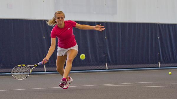 Sophomore Alyssa Steinweis sets up for a forehand during her singles match vs. St. John Fisher College on Saturday in the Athletic and Events Center.