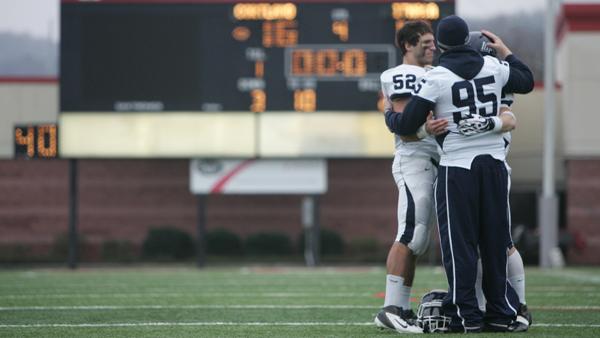 Members of the Ithaca Bombers football team console each after losing the 54th annual Cortaca Jug football game 16-10 to SUNY-Cortland on Saturday in Cortland, N.Y.