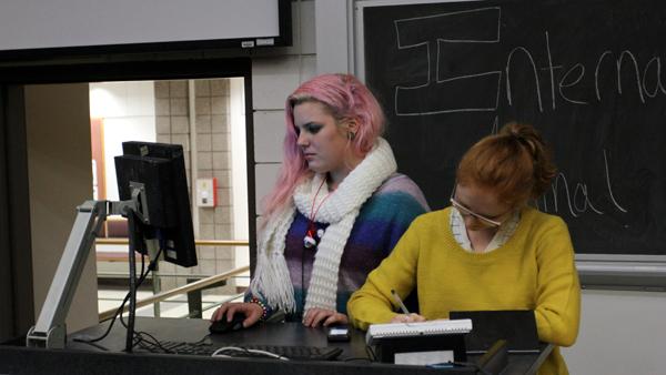 From left, sophomores Karly Placek, president of the Animal Rights club, and Dorothea Hinman, treasurer, screen a movie Monday in Williams 323.