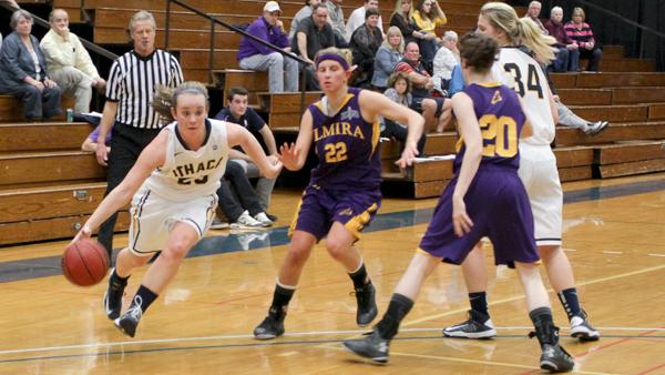 From left, sophomore guard Ally Mnich drives past Elmira College junior guard Jessica Zoltowski during the Bombers 66-46 victory Tuesday night in Ben Light Gymnasium.