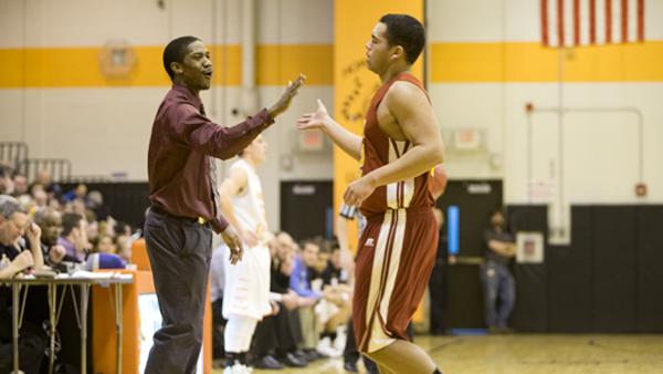 Coach Jobe Zulu gives a high-five to sophomore forward Cole Clemons during a game against Union-Endicott.