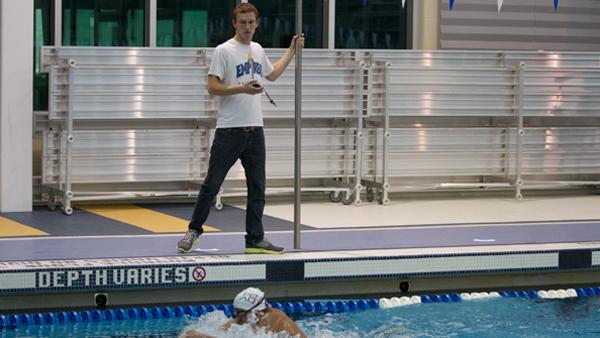 Assistant Coach James Sica  oversees a practice in the Athletics and Event Center pool.