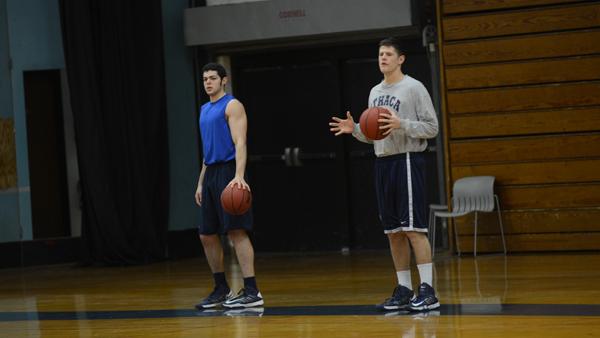 From left, senior forwards Travis Warech and Andrei Oztemel look on during a basketball practice in Ben Light Gymnasium on Tuesday. Both have injuries that have kept them sidelined for the past three games.	