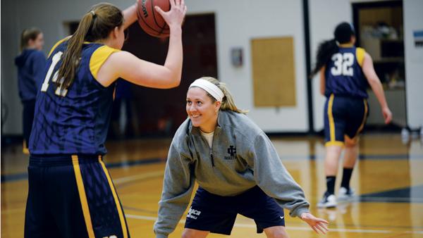 Assistant Coach Katherine Bixby plays defense for a drill during a women’s basketball practice in Ben Light Gymnasium on Feb. 5.
