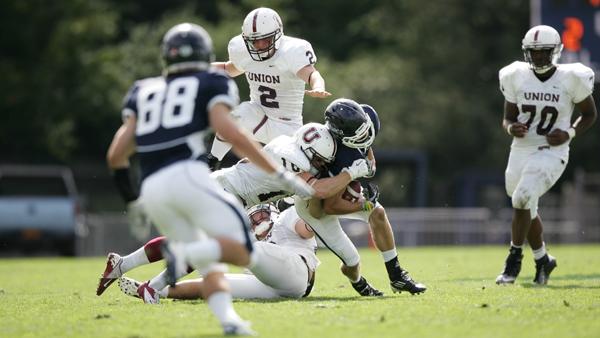 Senior wideout JJ Crandall receives a blow to the head from senior outside linebacker Connor Beerworth after catching a pass during the Bombers’ 27-24 victory over Union College last season.