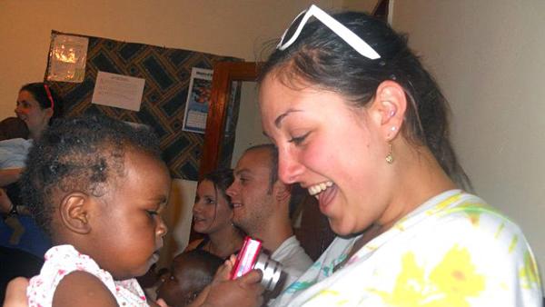 Senior Madeline Apuzzo holds a Malawian orphan at the Crisis Nursery in 2011. Apuzzo went on the study abroad trip to Malawi with Mary Taylor, a nurse at the Hammond Health Center, as well as six other students.
