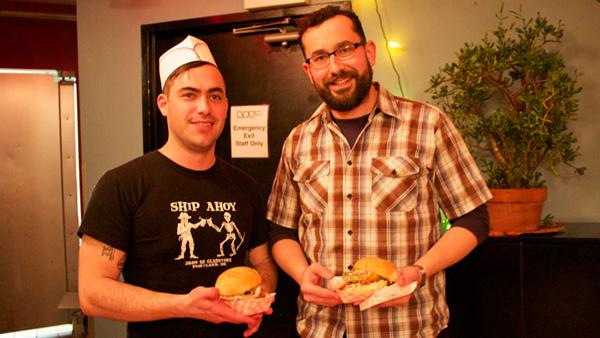From left, Belly Ithaca owners Manny Flores and Gentry Morris hold their food at Belly Ithaca, located on the bottom floor of Lot 10 on The Commons. The two opened Belly Ithaca on Feb. 15. They sell street food at the restaurant.
