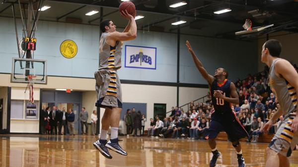 Travis Warech takes a jumpshot during a game against Utica College in Ben Light Gymnasium