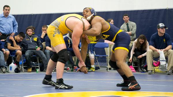 Senior captain Jules Doliscar takes down an opponents in a dual-meet in Ben Light Gymnasium.