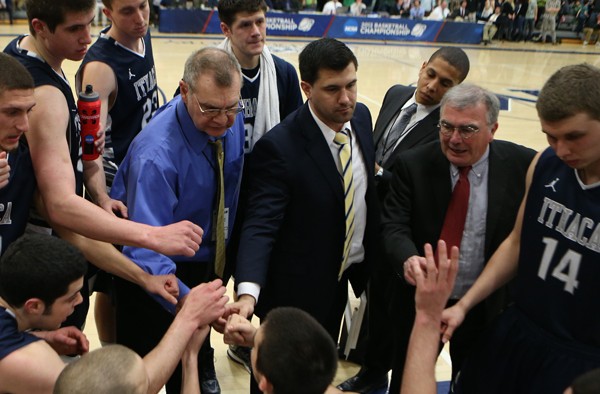 The team gathers around Head Coach Jim Mullins during a huddle in the second half.
