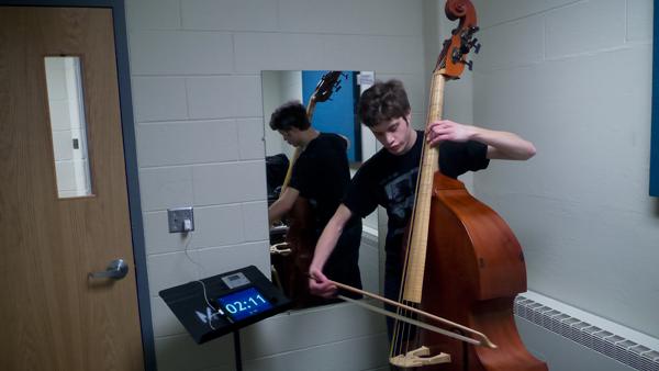 Junior John DiCarlo practices March 19 in room 1315 of the Whalen Center for Music. DiCarlo is a double bass performance major and said he uses his emotions to help him connect with his music and audience.