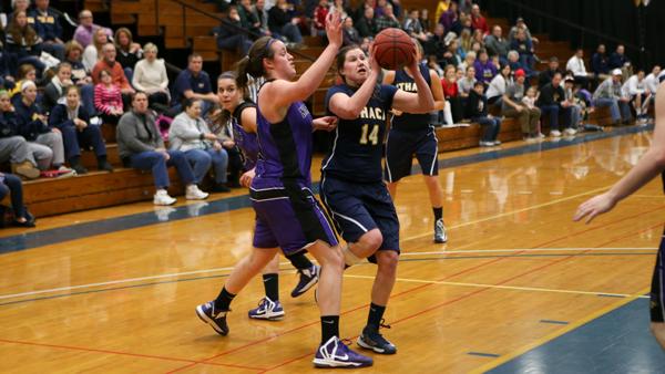 Junior guard Mary Kate Tierney attempts to put a shot past Nazareth College sophomore center Maria Allocco during the Bomber’s final regular season game Feb. 16 in Ben Light Gymnasium.