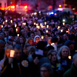 Mourners attend a candlelight vigil for 8-year-old Martin Richard near Dorchester on Tuesday. Richard was killed in the bombings Monday.  Josh Haner/The New York Times