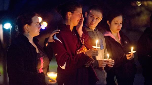From left, freshmen Jen Goehring, Kristen Pompey, Cameron Fitch and Lindsey Adelstein attend a vigil at the Textor Ball on Wednesday. It was held  to remember the victims of the Boston Marathon explosions, which left three people dead and 176 injured Monday. Thirty-four people attended the vigil.