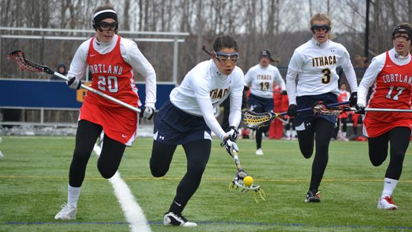 From left, SUNY-Cortland sophomore Marilyn Farrell runs alongside as senior Tracy Rivas picks up the ball March 23 in Higgins Stadium. The Bombers lost the contest by a score of 8-9. 