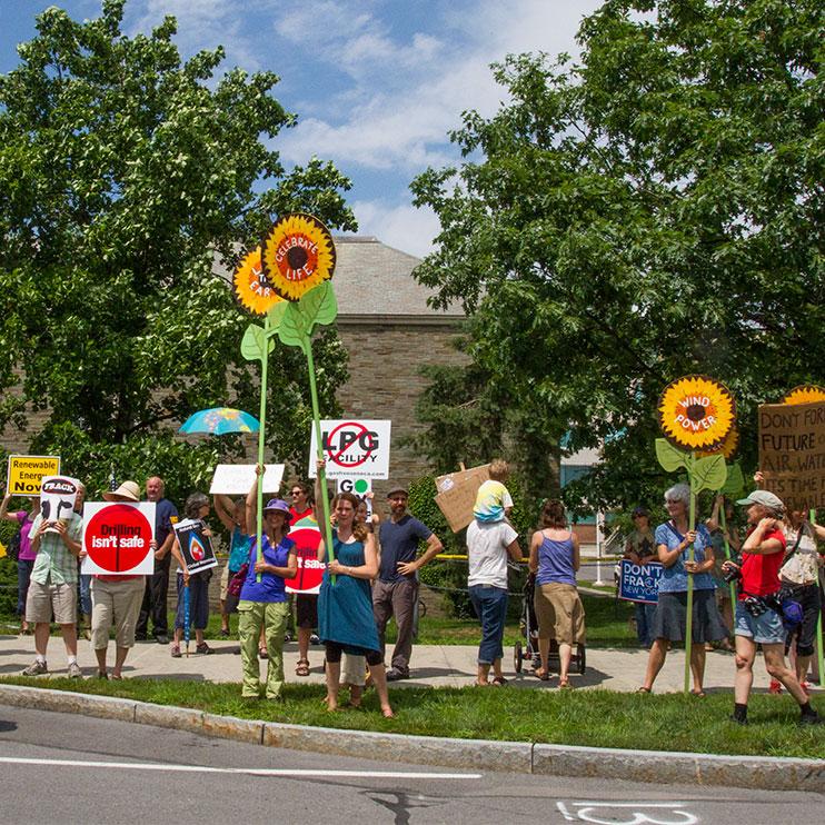 Kat Stevens, a member of Shaleshock and the Finger Lakes Action Network, speaks into a megaphone Wednesday during a protest to encourage Governor Andrew Cuomo to ban fracking in New York while he was attending a meeting in Schoellkopf Hall at Cornell University. 