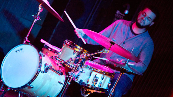 Greg Evans, jazz studies lecturer at Ithaca College and Cornell University, plays the drums during a jam session at The Gates.