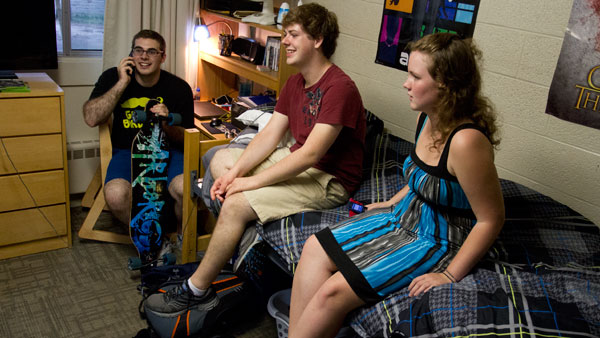 From left, Ithaca College sophomores Nick Pittman, Chris Dexter and Beth Dellea spend time with friends in a same-sex room in the quads on campus.