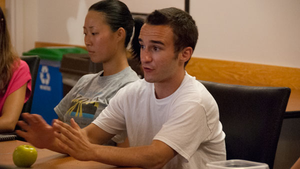 Junior Esther Kim, School of Health Sciences and Human Performance senator, and sophomore Sean Themea, Class of 2016 senator, discuss their plans for the year during the first SGA meeting.