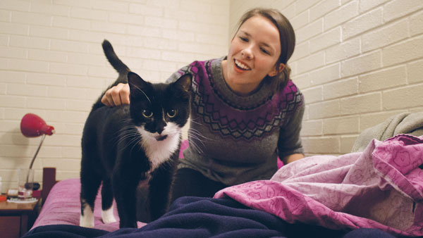 Junior Meredith Knowles plays with her cat, Arya. Residential Life allows Knowles to keep Arya in her room to help relieve her anxiety.