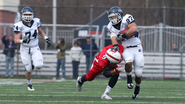 Clay Ardoin 13 runs the ball as SUNY Cortland then freshman Andre Green tries to tackle during the Cortaca Jug game on Nov. 10, 2012.
