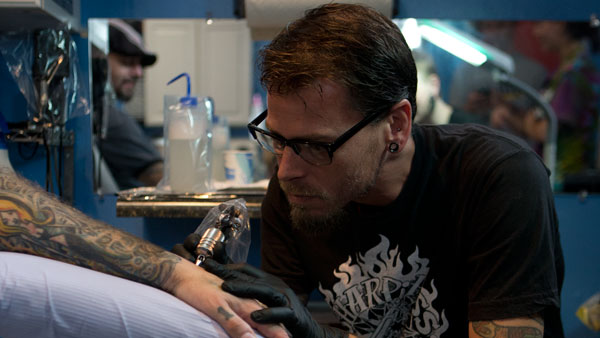 James Spiers, owner of Model Citizen Tattoo, inks Ithaca resident Noah Drew.