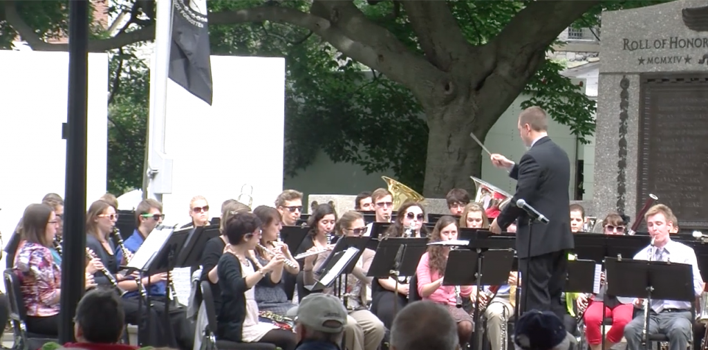 The James J. Whalen School of Musics Wind Ensemble performs on a sunny day in Dewitt Park for the Ithaca community.