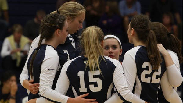Members of the volleyball squad huddle together during the Bomber Invitational on Sept. 6 in Ben Light Gymnasium.