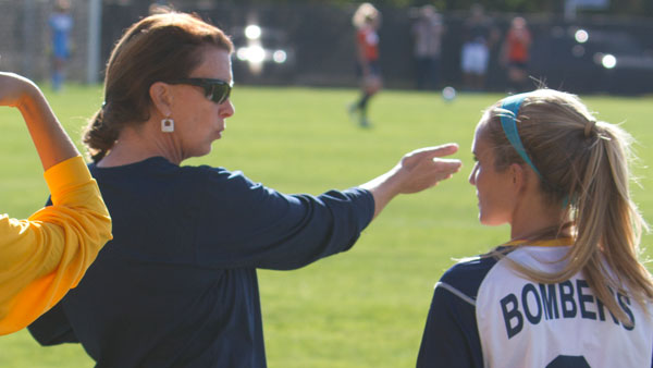 Mindy Quigg, womens head soccer coach, speaks to freshman forward Holly Niemiec during the Bombers home contest with Utica College on Wednesday afternoon on Carp Wood Field.