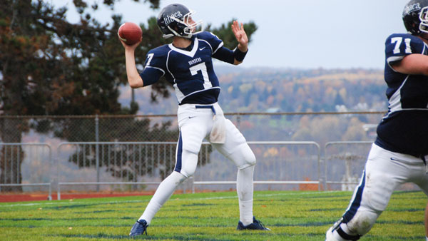 Senior quarterback Tom Dempsey drops back to throw the ball during the football teams 23–0 win against Frostburg State University.