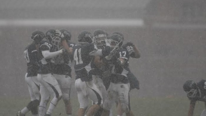 The football team celebrates after clinching its victory against Framingham State on Nov. 23 at Butterfield Stadium.