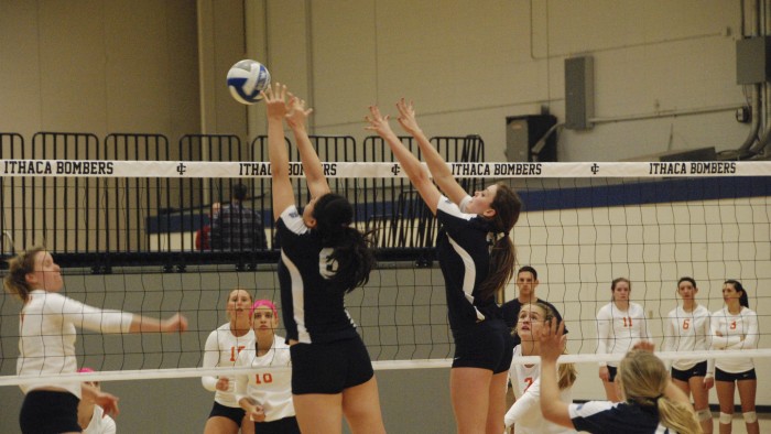 Freshmen Grace Chang and Breanne Tuohy jump up for a block in the Bombers 3–1 tournament victory against Utica College on Oct. 11 in Ben Light Gymnasium.
