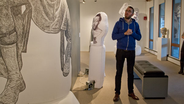 Artist Benjamin Entner stands by pieces in “Sumus: Figurative Sculpture Through the Ages,” during the exhibit’s opening Nov. 14 in the Handwerker Gallery.