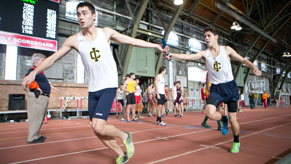 From left, junior Mason Mann receives the baton from freshman Chris Gutierrez at the Cornell Relays on Dec. 7 at Cornell University.