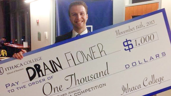 Junior Zach Briggs poses with his prize money Nov. 14 during Ithaca College’s third annual Business Idea Competition. Briggs won first place in the Lifestyle category for his idea.