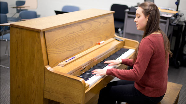 Sophomore Emily Behrmann-Fowler, who is pursuing a dual degree in vocal performance and theater arts management, plays piano and sings Jan. 29 in the Whalen Center for Music.