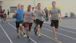 From left, juniors Kevin Davis, Rashaad Barrett and Ty Curtis run down the backstretch during an interval workout at the men’s track and field team’s practice Jan. 27 in Glazer Arena.   Jillian Flint/The Ithacan