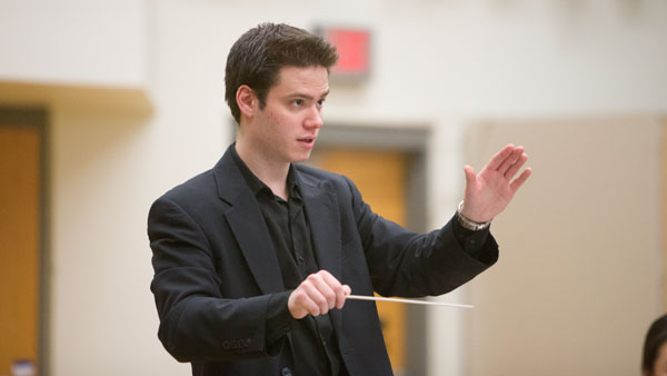 Senior Joshua Condon conducts a rehearsal for “Disney in Concert: Tale as Old as Time.”